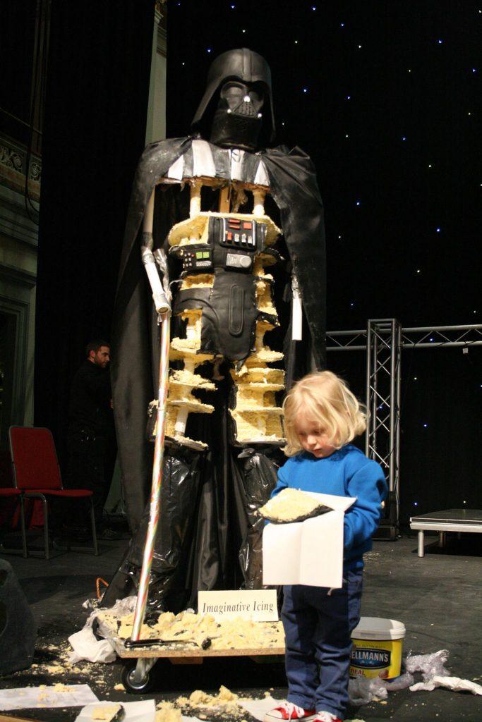 Darth Vader Cake - 7foot tall with small boy with huge slice of cake for scale ;) created for Sci-Fi Scarborough in 2015 