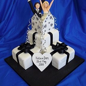 Wedding Cake shaped as Wedding Parcels with Bride & Groom bursting out of the top