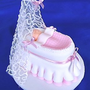 Baby in Frilly Icing Crib with Filigree piping